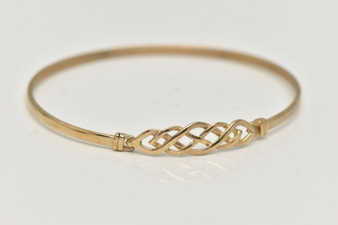 A 9CT GOLD BANGLE, a Celtic design light weight bangle, fitted with a hook fastening, hallmarked 9ct - Image 1 of 4