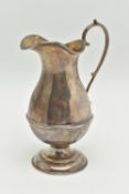 A GEORGE V SILVER CREAM JUG, a baluster form jug with a scrolling handle, approximate height