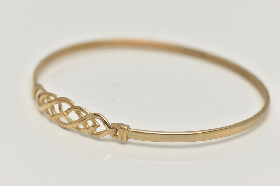 A 9CT GOLD BANGLE, a Celtic design light weight bangle, fitted with a hook fastening, hallmarked 9ct - Image 2 of 4