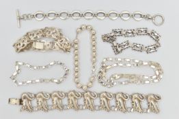 SIX ITEMS OF WHITE METAL JEWELLERY, to include a swan bracelet, a scrolling acanthus panel bracelet,