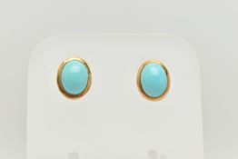 A PAIR OF STUD EARRINGS, designed as oval blue cabochons in collet settings, stamped 750,