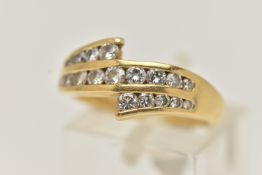 AN 18CT GOLD DIAMOND RING, a three row channel set diamond ring, set with graduated round