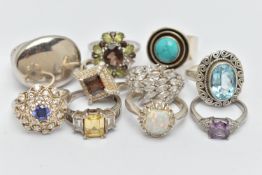 TEN SILVER AND WHITE METAL RINGS, to include an oval topaz ring, a large oval panel ring, a circular
