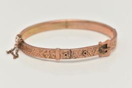 A 9CT GOLD HINGED BANGLE, a rose gold buckle style bangle, etched with foliage detail, approximate