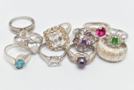 TEN WHITE METAL RINGS, to include an oval topaz ring, a textured band ring, various cubic zirconia