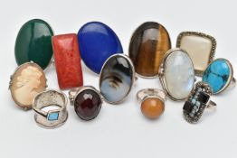AN ASSORTMENT OF THIRTEEN WHITE METAL RINGS, large statement rings, each set with a hard stone or