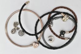 FOUR PANDORA CHARM BRACELETS AND CHARMS, to include two woven leather examples, a bangle and an