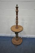 A LATE 20TH CENTURY OAK STANDARD LAMP, with geometric carvings, a circular shelf and base, raised on