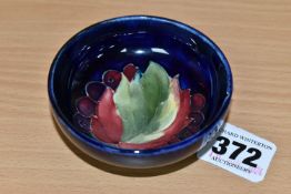 A MOORCROFT POTTERY 'LEAF AND BERRIES' SMALL FOOTED BOWL, tube lined in the Leaf and Berries pattern