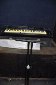 A WERSI PEGASUS KEYBOARD (SPARES OR REPAIRS) in hard case with a stand (Condition Report: no