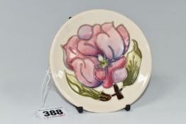 A MOORCROFT POTTERY MAGNOLIA TRINKET DISH, tube lined in pink Magnolia pattern on a cream ground,
