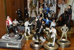A COLLECTION OF MUSICAL 'ELVIS' FIGURINES, comprising four Franklin Mint music box figures, 'Burning