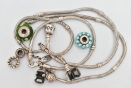 FOUR PANDORA CHARM BRACELETS WITH CHARMS, to include four snake chain charm bracelets, one with