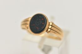 AN 18CT GOLD BLOODSTONE SIGNET RING, designed as a polished oval bloodstone inlay, collet set to the