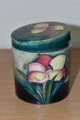 A MOORCROFT POTTERY 'FREESIA' PATTERN COVERED JAR, of cylindrical form, tube lined with pale