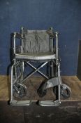 AN AIDAPT FOLDING WHEELCHAIR with two footrests and seat cushion (condition report wear to one front