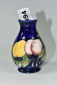 A MOORCROFT POTTERY 'WISTERIA' PATTERN VASE, of small ovoid form, tube lined with purple, pink and