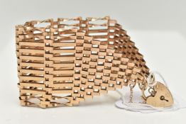 A 9CT GOLD WIDE GATE BRACELET, twelve bar bracelet, approximate width 41.8mm, fitted with a heart
