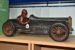 A COMPOSITE MODEL OF A RACING CAR AND DRIVER, with turning wheels, length approximately 70cm x
