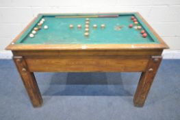 AN EARLY 20TH CENTURY OAK BUMPER POOL TABLE, with two cues, five red and five white balls, a