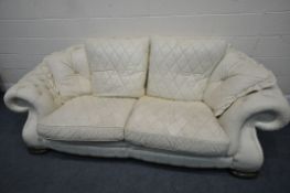 A CREAM BUTTONED LEATHER THREE PIECE LOUNGE SUITE, comprising a large two seater sofa, length