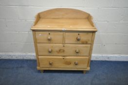 A VICTORIAN PINE WASHSTAND, with a raised back, fitted with two short over two long drawers,