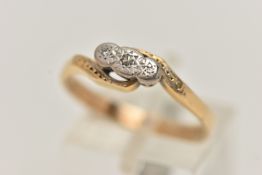 A YELLOW METAL DIAMOND RING, three single cut diamonds, illusion set in a white metal mount, cross