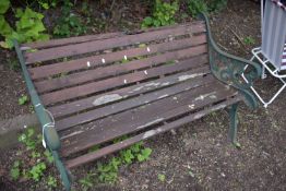 A CAST IRON GARDEN BENCH, with real slats (condition report: rickety and in need of attention)