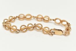 A 9CT GOLD FANCY LINK BRACELET, rope twist open work links, fitted with a lobster clasp, part