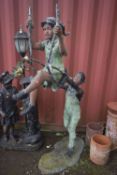 A BRONZE SCULPTURE, artist unknown, of two children playing in a park, with the girl on a swing,