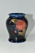A MOORCROFT POTTERY 'POMEGRANATE' PATTERN VASE, of small baluster form, tube lined with