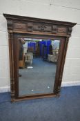 A 20TH CENTURY OAK OVERMANTEL MIRROR, with various carved details, turned and fluted supports, width