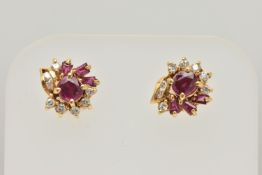 A PAIR OF YELLOW METAL RUBY AND DIAMOND EARRINGS, each designed as a cluster set with a central