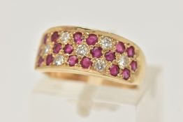 A 14CT YELLOW GOLD RUBY AND DIAMOND SET RING, pave set with circular cut rubies and brilliant cut