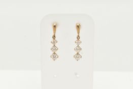 A PAIR OF YELLOW METAL CUBIC ZIRCONIA DROP EARRINGS, designed as a row of three graduated