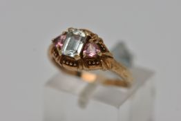 A 9CT GOLD GEM SET RING, a rectangular cut aquamarine prong set in yellow gold, flanked with two
