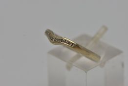 A 9CT GOLD SHAPED DIAMOND BAND RING, eleven round brilliant cut diamonds, channel set in a shaped