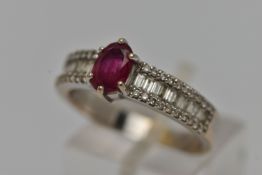 A GEM SET RING, an oval cut ruby in a prong setting, flanked with baguette and round brilliant cut