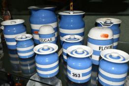 ELEVEN PIECES OF TG GREEN CORNISHWARE, comprising sugar and flour sifters, five small canisters,