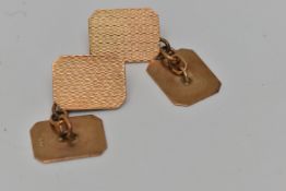 A PAIR OF YELLOW METAL CUFFLINKS, each of a rectangular form with engine turned pattern, chain