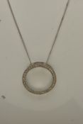 A 9CT GOLD DIAMOND PENDANT, a circular form white gold pendant, grain set with round brilliant cut
