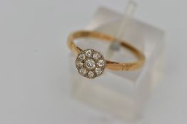 A DIAMOND CLUSTER RING, designed with a central old cut diamond surrounded by eight old cut