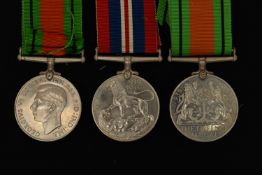 THREE WW2 MEDALS, to include two Defense Medals with ribbons and a 1939-1945 war medal with ribbon