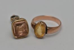 TWO EARLY 20TH CENTURY JEWELLERY ITEMS, the first an oval cut citrine, collet set in rose metal,