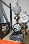 TWO GILT METAL OIL LAMPS WITH GLASS SHADES AND CHIMNEYS, height of tallest 73cm to top of chimney, a