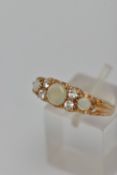 A 9CT GOLD GEM SET RING, three round opals, prong set in yellow gold, accented with one circular cut