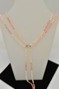 A BEADED CORAL NECKLACE, a three strand coral necklace with small yellow metal beads, fitted with