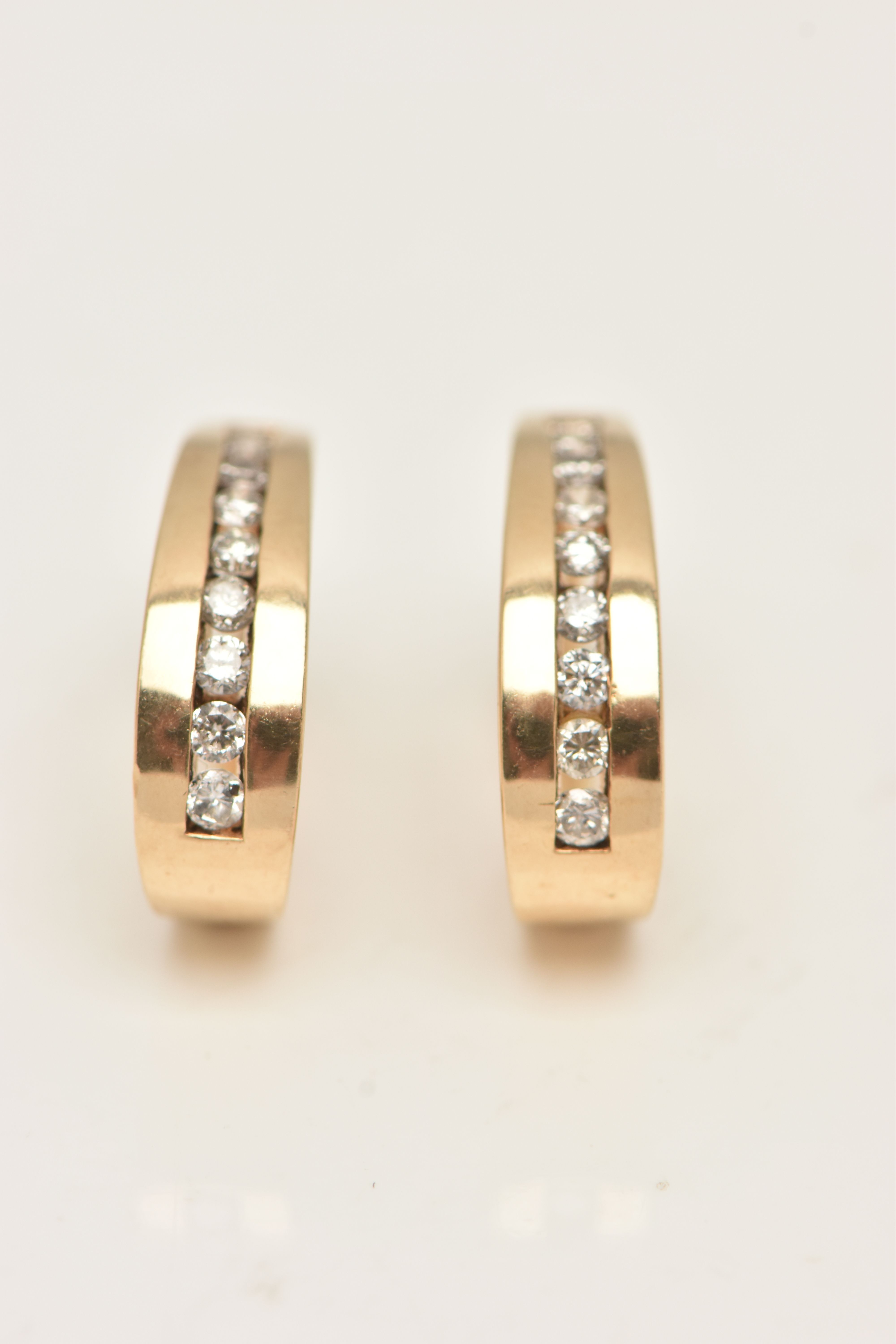 A PAIR OF 9CT GOLD DIAMOND HOOP EARRINGS, yellow gold half hoop, channel set with round brilliant