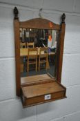 MEUBELFABRIEK OISTERWIJK, A DUTCH SMALL OAK WALL MIRROR, with twin finials, and a hinged storage