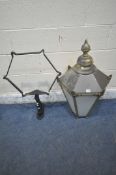 A BRASS HEXAGONAL TAPERED WALL HANGING LANTERN, with a finial and metal bracket, height